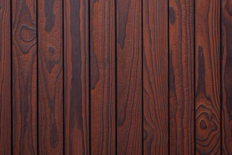 Close-up texture detail of vertical charredwoodcanada ltd reddish-brown Thermo Pinus Radiata charred wood cladding boards, featuring a brushed surface that highlights the natural wood knots, deep grain, and dark crackled Yakisugi charring patterns.