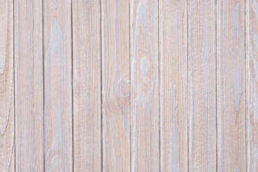 Close-up texture detail of vertical charredwoodcanada ltd pale silver Thermo Pinus Radiata charred wood cladding boards, featuring a brushed surface that highlights the weathered wood knots and soft grain textures.