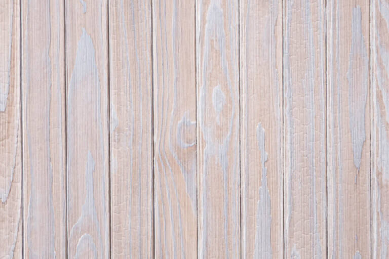 Close-up texture detail of vertical charredwoodcanada ltd pale silver Thermo Pinus Radiata charred wood cladding boards, featuring a brushed surface that highlights the weathered wood knots and soft grain textures.
